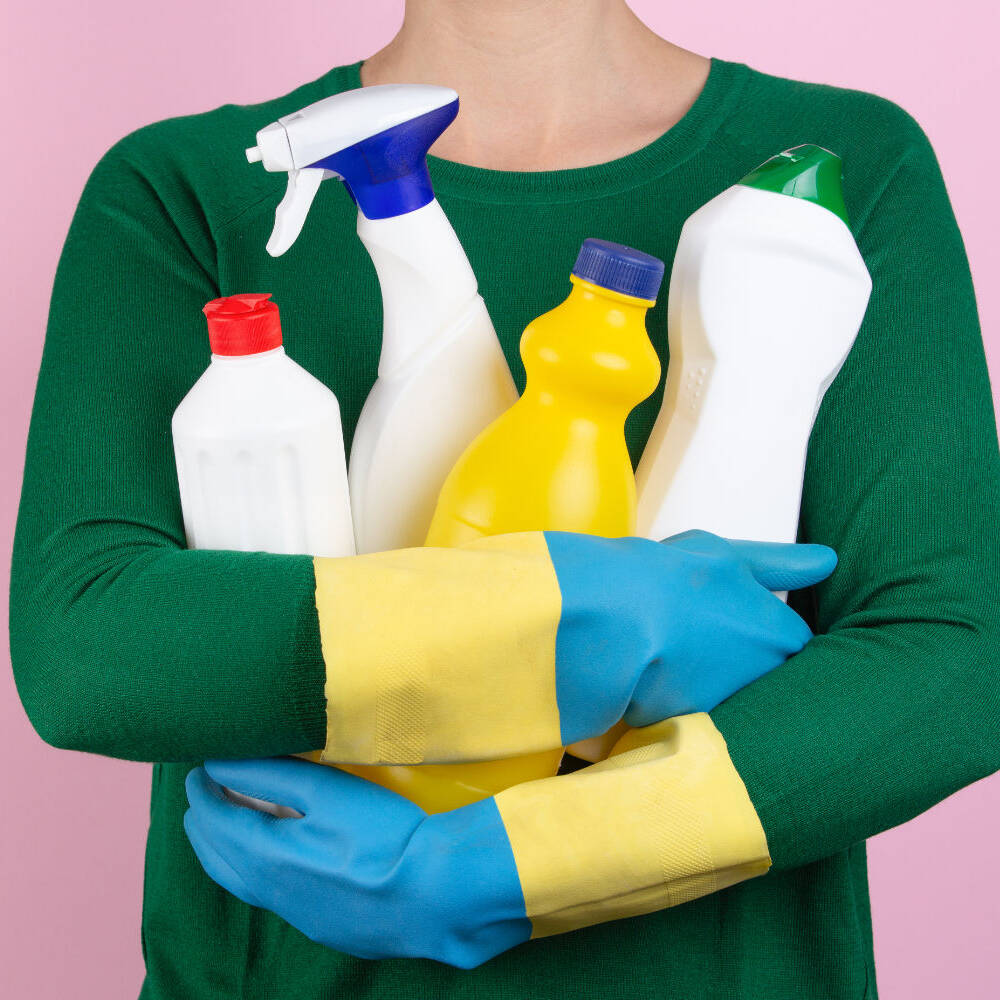 woman with many cleaning products in her arms globex