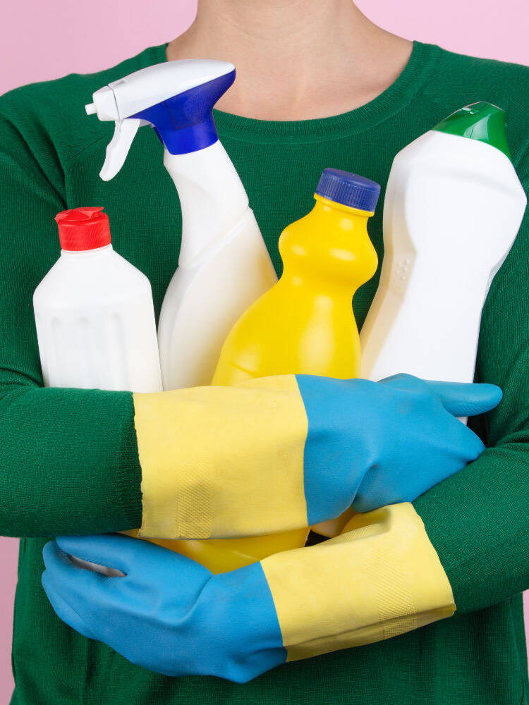 woman with many cleaning products in her arms globex